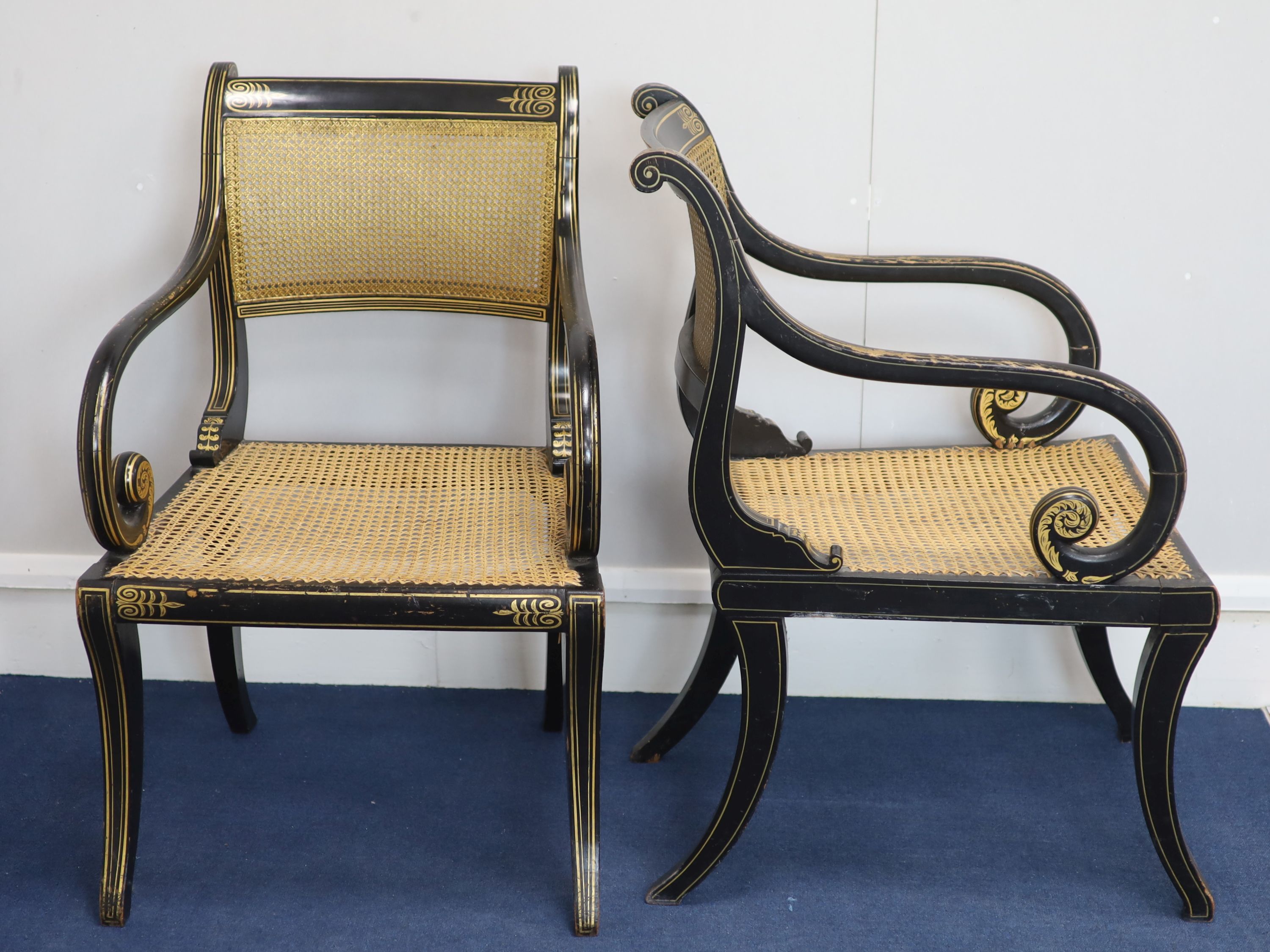A set of seven Regency style parcel-gilt decorated ebonised armchairs, 19th century,